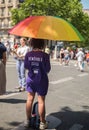 Gay Pride Parade Day. Volunteer girl from behind wearing a purple shirt saying `Benevole inter-Lgbt`