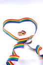 Gay pride rainbow curly ribbon in the shape of a heart isolated on white background. Abstract LGBT minimal concept with two Royalty Free Stock Photo