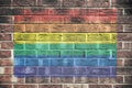 Gay pride rainbow flag on brick wall background Royalty Free Stock Photo