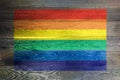 Gay pride rainbow flag on rustic old wood surface background Royalty Free Stock Photo