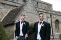 Gay wedding, grooms leave village church after being married with big smiles and holding hands