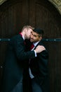 Gay wedding, grooms leave village church after being married and kiss