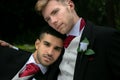 Gay weddings, grooms, couples pose for pictures after their wedding ceremony in churchyard Royalty Free Stock Photo