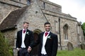 Gay wedding, grooms leave village church after being married to smiles and confetti Royalty Free Stock Photo