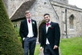 Gay wedding, grooms leave village church after being married with big smiles and holding hands