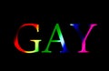 Gay word in rainbow colours isolated on black background. Homosexuality concept