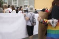 GayPride spectators carrying banners with copy space during Pride parade. Rainbow colors cloth
