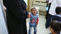 Gaza city, a young crying and attended to by a doctor in a hospital