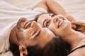 Gaze at the ceiling and make lame jokes. a young couple having an intimate moment on the bed at home. Royalty Free Stock Photo