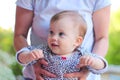 gaze of a smiling little child with blond hair in mom& x27;s hands Royalty Free Stock Photo