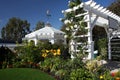 Gazebo and arch in lush garden Royalty Free Stock Photo
