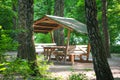 Gazebo in a green forest in the rays of the sun Royalty Free Stock Photo