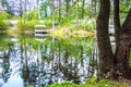 Gazebo. The lake reflects forest trees