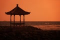 Gazebo on the ocean shore at sunset. Indonesia, Bali Royalty Free Stock Photo