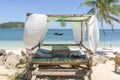 Gazebo for relaxing with white curtains on tropical sand beach near blue sea water on island Koh Phangan, Thailand Royalty Free Stock Photo