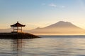 Gazebo at Sanur beach with Mt Agung volcano background during sunrise Royalty Free Stock Photo