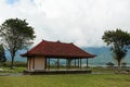 The gazebo stands on a cloud-shrouded mountain on the popular tourist island of Bali