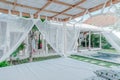 Gazebo with a wooden bed under a mosquito grid on a outside