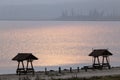 Gazebos on the lake against the sunlight.