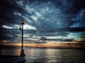 Gazed upon the lord beautiful creation a view of twilight with the bow light post on the shore of the pier Royalty Free Stock Photo