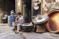 Young craftsman makes copper utensils