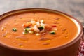 Gazpacho soup in crockpot on wooden table