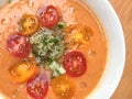 gazpacho soup with slised tomatoes, cucumber, pepper and oil drops. top view. close-up