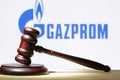 Gazprom . A hammer on the table against the background of the Gazprom logo. The concept