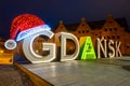 Gdansk city sign with Christmas hat in Old Town of Gdansk at night. Poland Royalty Free Stock Photo