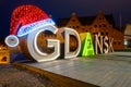 Gdansk city sign with Christmas hat in Old Town of Gdansk at night. Poland Royalty Free Stock Photo