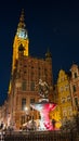 Gdansk - The Neptune's Fountain in Old Town of Gdansk, Poland at night. The fountain is lit with red and white lights. Royalty Free Stock Photo