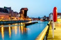 Gdansk night city riverside view. View on famous crane and facades of old medieval houses Royalty Free Stock Photo