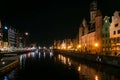 Gdansk - A night view on the shores of Martwa Wisla flowing through Gdansk in Poland, with medieval port crane