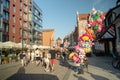 Gdansk, North Poland - People enjoying leisure activities and a balloon seller sitting on a pavement during