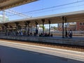 Gdansk, North Poland: View of intercity train station and tracks against bunch of passengers waiting to board