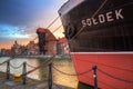 Gdansk, Poland - April 16, 2019: Old town of Gdansk wth Soldek ship at sunset, Poland. Gdansk is the historical capital of Polish Royalty Free Stock Photo