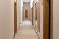 Modern architecture, interior, view of the long corridor and doors at new apartment building