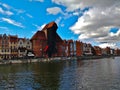 Old historical wooden crane house surrounded with typical Gdansk city center buildings during Summer weather Royalty Free Stock Photo