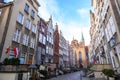 Mariacka street with colorful facades of tenement houses and 16th century gothic St. Mary`s Church, Gdansk, Poland Royalty Free Stock Photo