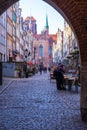 Mariacka street with colorful facades of tenement houses and 16th century gothic St. Mary`s Church, Gdansk, Poland Royalty Free Stock Photo