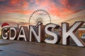 Gdansk sign at beautiful sunset at ferris wheel