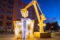 Gdansk, Poland - January 5, 2020: Illuminated decorations in the shape of crane lifting christmas present in Gdansk, Poland.