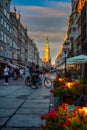 Gdansk, Poland - July 4, 2022: People are walking on the beautiful old town in Gdansk with historical city hall at sunset, Poland Royalty Free Stock Photo