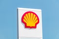 Shell gas station logo on blue sky.
