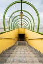 Small tunnel with yellow walls and green arcs and with downstairs to underground passage under
