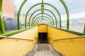 Small tunnel with yellow walls and green arcs and with downstairs to underground passage under