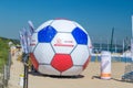 A large inflatable ball with a logos of Polish Football Association and Lotos