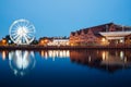 Polish Baltic Philharmonic and ferris wheel with river at night in Gdansk, Poland Royalty Free Stock Photo