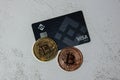 Gdansk Poland - May 2022 Bitcoin gold coin with Black Binance Card mining trading concept. Visa debit card BNB, Binance