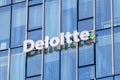 Logo and sign of Deloitte.